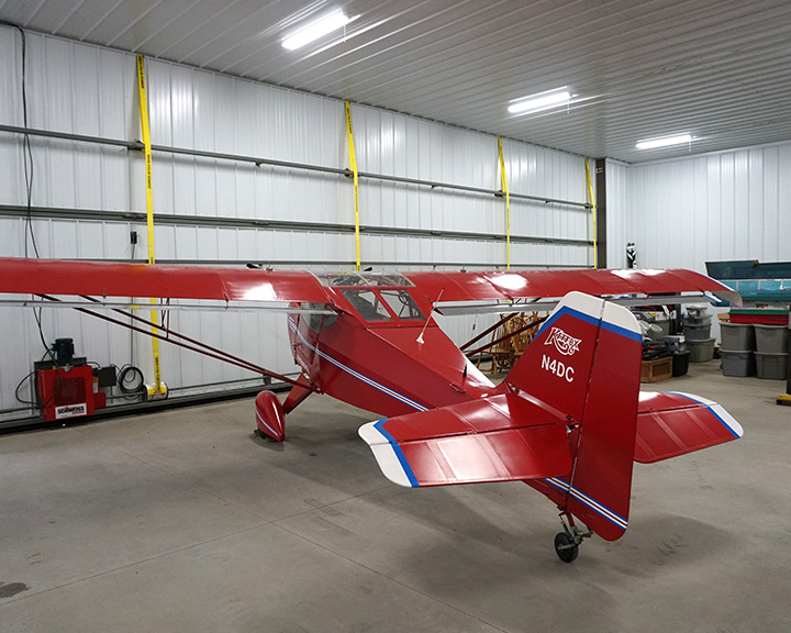 Inside Airplane Hanger with Red Colored Airplane Inside