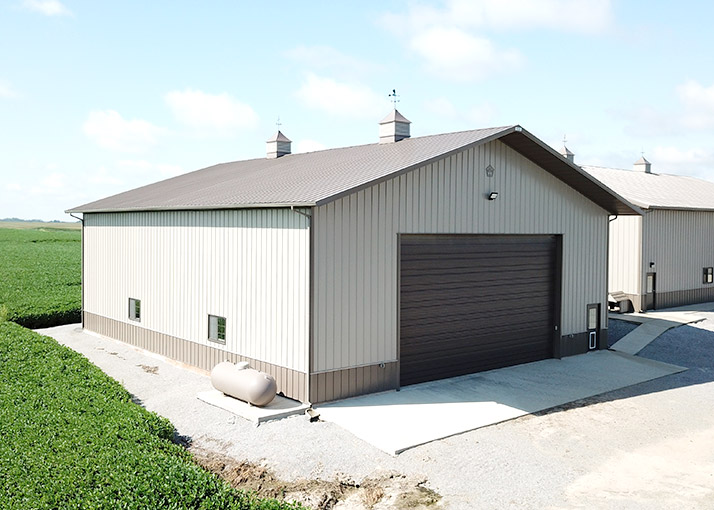 White Equipment and Storage Barn With Brown Door