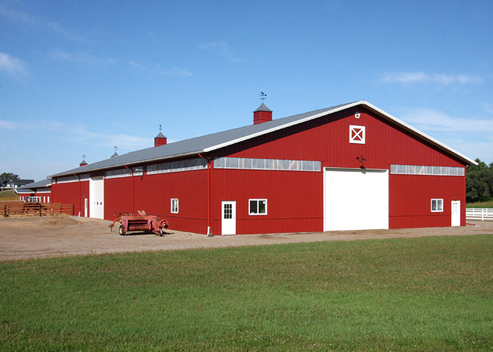 Riding Arena With Red siding and Gray Roof