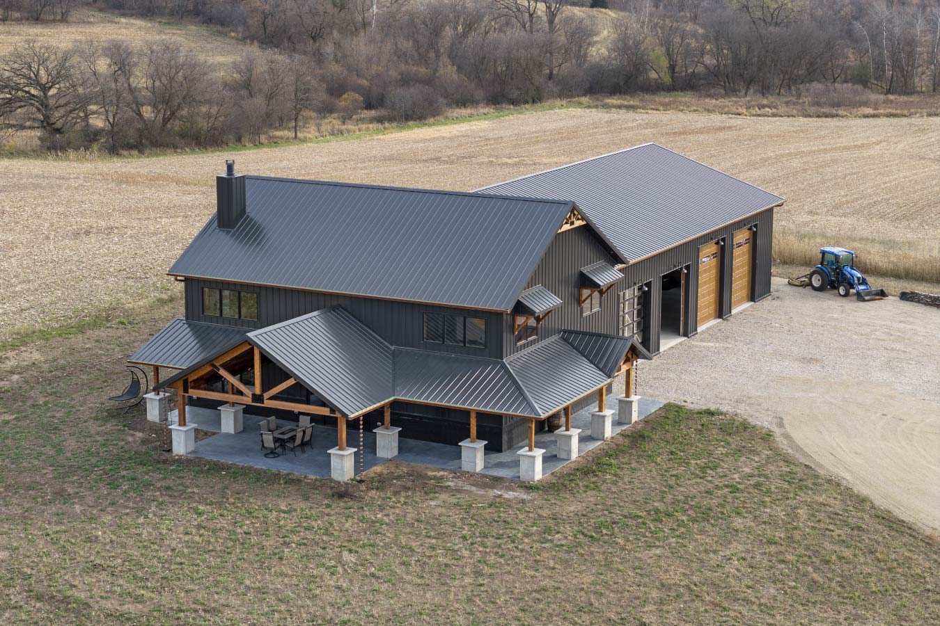 An aerial perspective showcases the full scale of the barndominium and workshop, nestled in the peaceful countryside.
