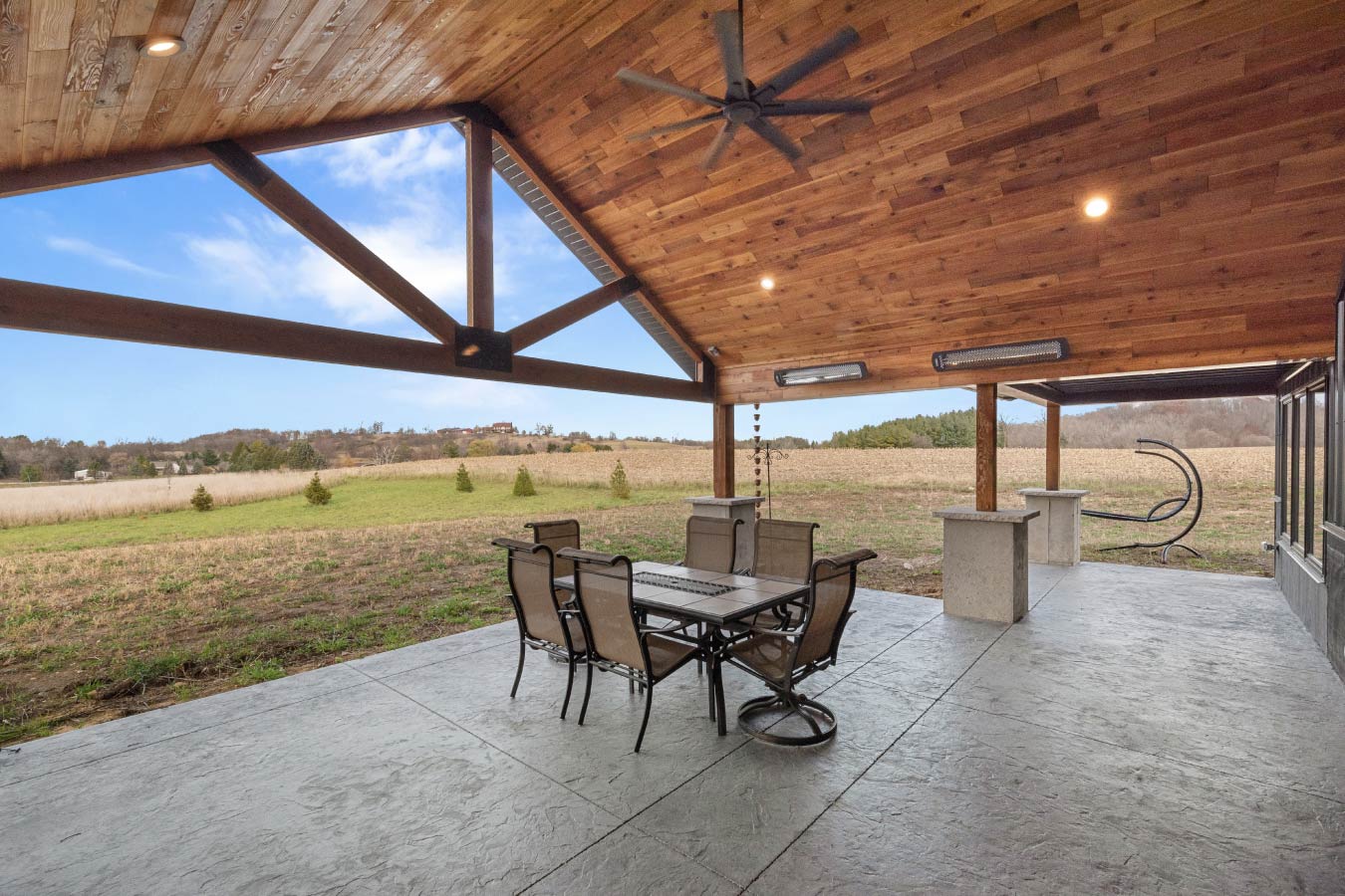 A modern and rustic outdoor space at the Barndominium with Workshop, blending metal siding and warm wood tones.