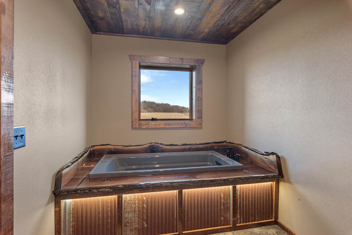 A luxurious soaking tub set against a rustic backdrop, perfect for relaxation.